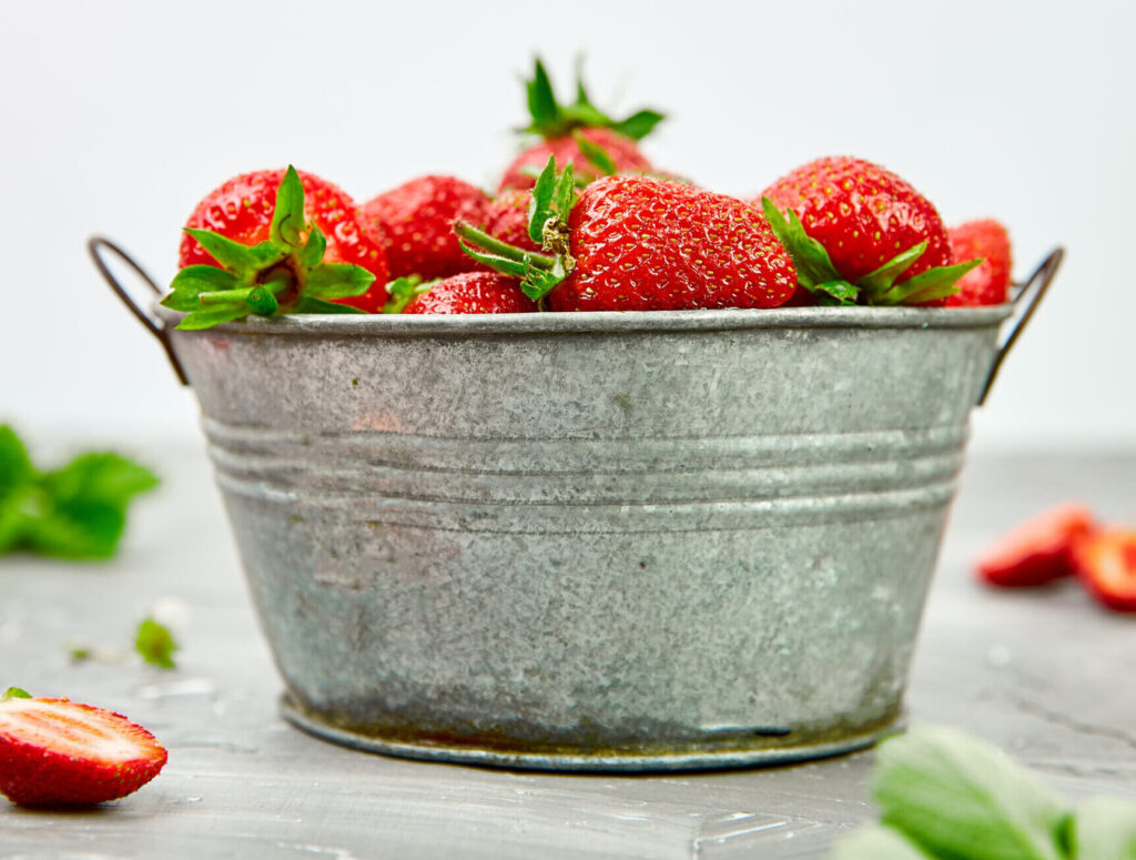 Strawberries in grey bowl.